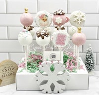 cake pops in a box with a snowflake on top