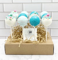 cake pops in a box with blue sprinkles